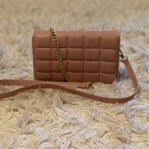 Light pink crossbody purse.